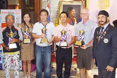 The flight winners of the 20th Sirindhorn’s Cup Golf Tournament pose for a photo with Lions Club President-elect of 2011-2012, Montri Sachdev (right).